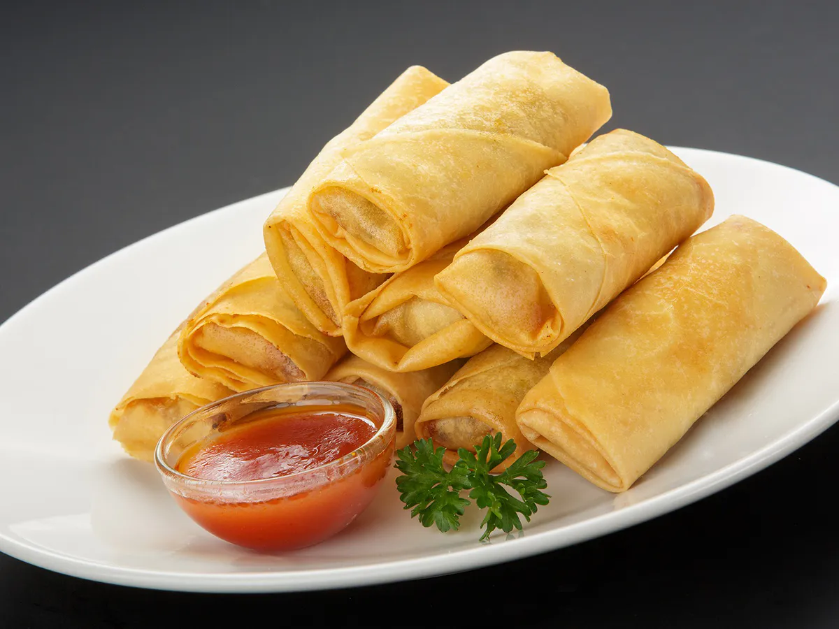 Crispy spring rolls served with a side of red dipping sauce at Green Jade, a Chinese Restaurant in St Marys
